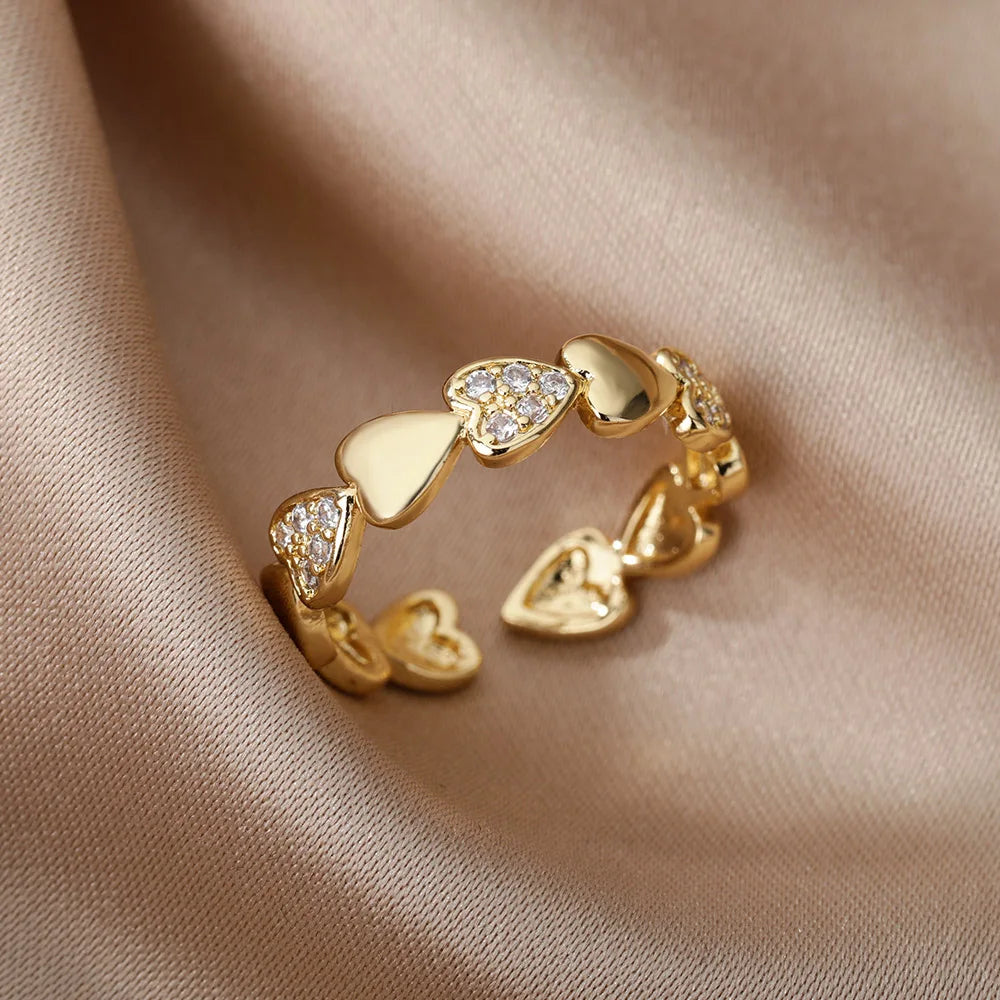 Elegant geometric heart ring with sparkling zircon accents and a luxurious gold-color finish. Made from durable stainless steel, perfect for weddings, everyday wear, or a stylish couple gift.